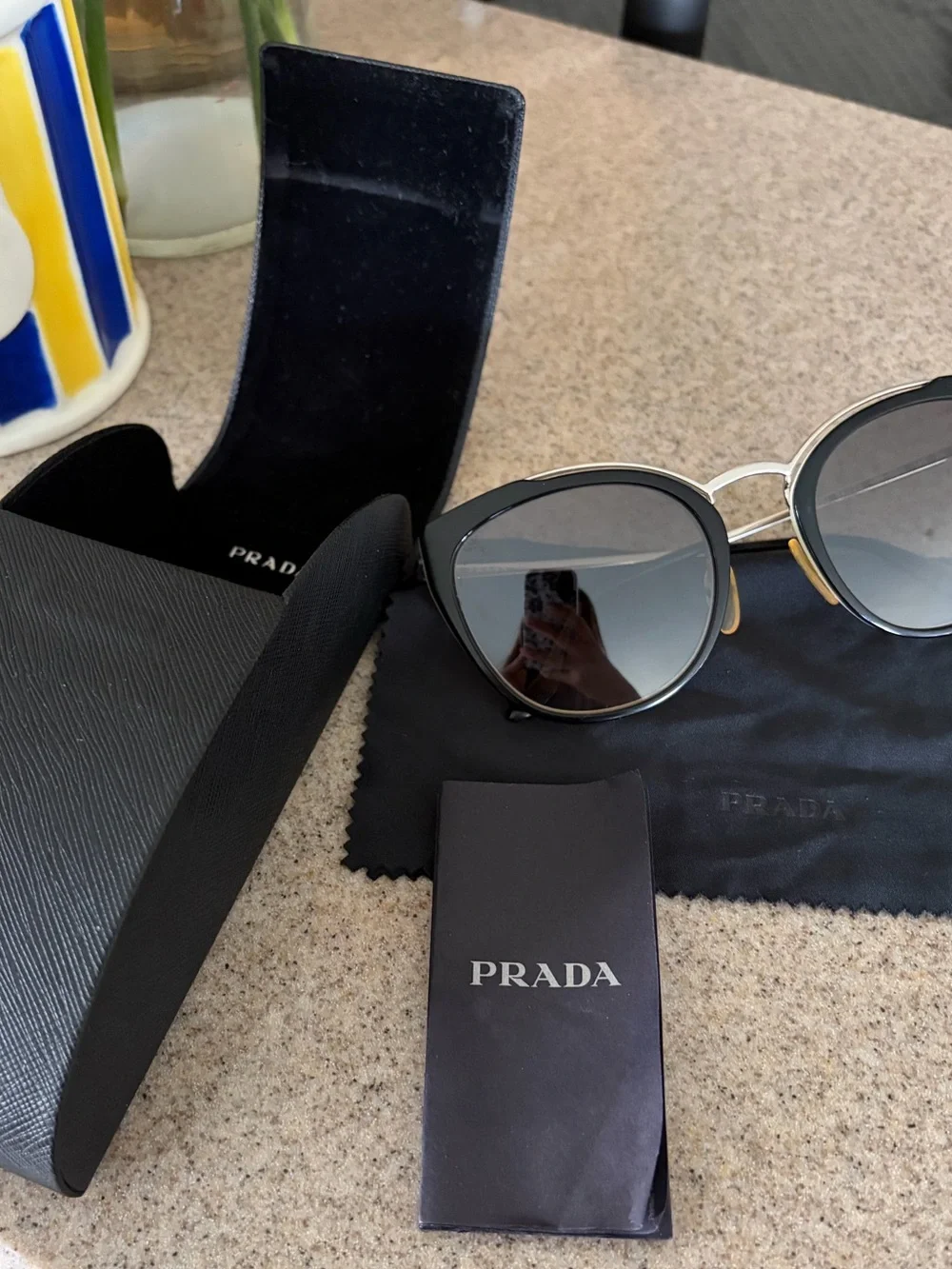Prada Black and Gold Cat-Eye Sunglasses with Gradient Lenses